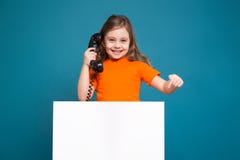 Cute little girl in tee shirt with brown hair hold clean paper and have a phone talk Royalty Free Stock Images Cute little girl in tee shirt with brown hair hold clean paper and have a phone talk Royalty Free Stock Images