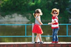 Cute little hugging children on the promenade stock image Cute little hugging children on the promenade stock image