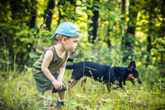 Little boy in forest with a dog, friendship