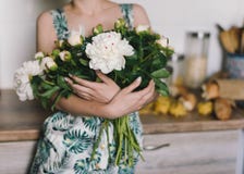 Cute and lovely peony flowers in women`s hands.. many layered petals. Bunch pale white peonies flowers light gray background Stock Image Cute and lovely peony flowers in women`s hands.. many layered petals. Bunch pale white peonies flowers light gray background Stock Image