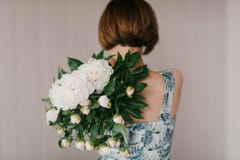 Cute and lovely peony flowers in women`s hands.. many layered petals. Bunch pale white peonies flowers light gray background Royalty Free Stock Images Cute and lovely peony flowers in women`s hands.. many layered petals. Bunch pale white peonies flowers light gray background Royalty Free Stock Images