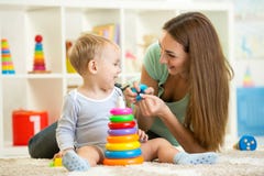 Cute mother and child boy play together indoor at stock photo Cute mother and child boy play together indoor at stock photo