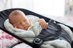 Cute Newborn Baby Boy, Sleeping In A Swing Royalty Free Stock Photos