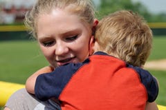 Cute Teen Girl Comforting and Holding small boy royalty free stock photo Cute Teen Girl Comforting and Holding small boy royalty free stock photo