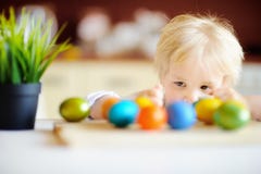 Cute toddler child hunting for easter egg on Easter day Royalty Free Stock Images Cute toddler child hunting for easter egg on Easter day Royalty Free Stock Images