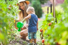 Cute toddler helphing mom in the garden royalty free stock image Cute toddler helphing mom in the garden royalty free stock image