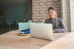 Cute woman successful freelancer using laptop computer while sitting in coffee shop royalty free stock photos Cute woman successful freelancer using laptop computer while sitting in coffee shop royalty free stock photos
