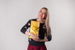Cute young woman holding gift box in her hands royalty free stock image Cute young woman holding gift box in her hands royalty free stock image