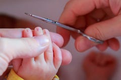 Cutting nails to a newborn baby a little mother care royalty free stock photography Cutting nails to a newborn baby a little mother care royalty free stock photography