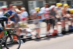 Cyclist racing in front of his fans behind the fences