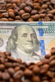 Cédula de 100 dólares americanos, entre grões do café Conceito do negócio para a compra, a venda, a entrega e a distribuição de imagens de stock Cédula de 100 dólares americanos, entre grões do café Conceito do negócio para a compra, a venda, a entrega e a distribuição de imagens de stock