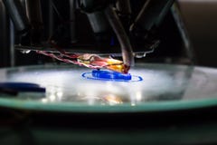 3d printing process close up. Automatic three dimensional 3d printer mechanism prints polymer blue part, component. Three royalty free stock image 3d printing process close up. Automatic three dimensional 3d printer mechanism prints polymer blue part, component. Three royalty free stock image