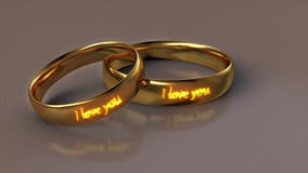 Wedding rings with appearing fiery text. I love you. Two wedding rings symbol of marriage and love. 3D rendering