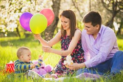 Dad and mom playing games with little son outside in spring blooming garden stock photos Dad and mom playing games with little son outside in spring blooming garden stock photos