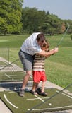 Dad Teaching Son Golf