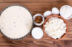 Dairy product for making casseroles at wooden table. Curd, milk, cheese and eggs. Organic farmer food. Top view with copy space.