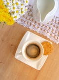 Daisies And Dandelions, A Cup Of Coffee And A Cookie On A Wooden Table Stock Images