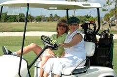 Dames aînées dans le chariot de golf Dames aînées dans le chariot de golf