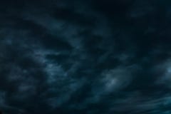 Dark Blue sky background with evening fluffy curly rolling altocumulus altostratus clouds royalty free stock photo Dark Blue sky background with evening fluffy curly rolling altocumulus altostratus clouds royalty free stock photo