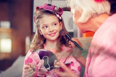 Dark-eyed Cute Girl Feeling Excited Doing Makeup With Granny Stock Image Dark-eyed Cute Girl Feeling Excited Doing Makeup With Granny Stock Image