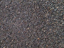 Dark grey sand surface, wet beach with volcanic sand background royalty free stock photography Dark grey sand surface, wet beach with volcanic sand background royalty free stock photography