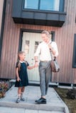Dark-haired cute schoolgirl going to school with her young handsome father stock image Dark-haired cute schoolgirl going to school with her young handsome father stock image