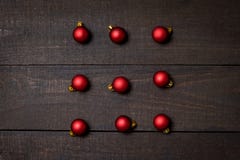 Dark rustic wood table flatlay - Christmas background with red christmas ornaments. Top view with free space for copy text stock images Dark rustic wood table flatlay - Christmas background with red christmas ornaments. Top view with free space for copy text stock images