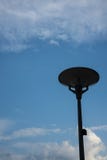 Dark street light isolated with cloudy blue sky royalty free stock photography Dark street light isolated with cloudy blue sky royalty free stock photography