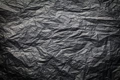 The dark texture of crumpled paper, black background stock photography The dark texture of crumpled paper, black background stock photography