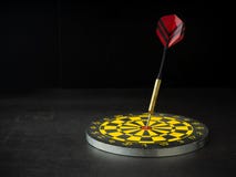 Dart arrow with board on black granite royalty free stock photography Dart arrow with board on black granite royalty free stock photography