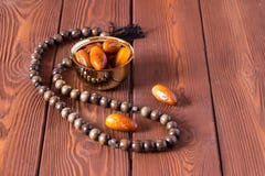 Dates fruit and rosary still life, on a brown wooden background royalty free stock photo Dates fruit and rosary still life, on a brown wooden background royalty free stock photo