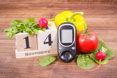 Datum 14 November, glukosmeter för att kontrollera sockernivån och grönsaker, världssockersjukadag och slåss sjukdombegrepp arkivfoto Datum 14 November, glukosmeter för att kontrollera sockernivån och grönsaker, världssockersjukadag och slåss sjukdombegrepp arkivfoto