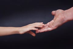 Daughter hand holds Fathers hand on dark blue background. Parental relationshipp concept royalty free stock photos Daughter hand holds Fathers hand on dark blue background. Parental relationshipp concept royalty free stock photos