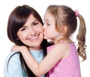 Daughter kissing her beautiful happy mother stock photo Daughter kissing her beautiful happy mother stock photo