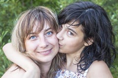 Daughter teenager kissing his young mother outdoors Family. stock images Daughter teenager kissing his young mother outdoors Family. stock images
