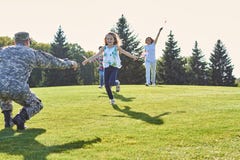 Daughters are running to their soldier father. stock photography Daughters are running to their soldier father. stock photography