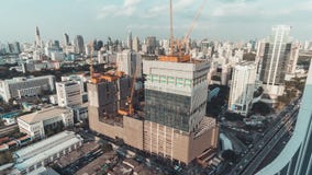 Day to night holy grail time-lapse of building construction site in city, end with traffic light trails and rain, aerial view stock video footage Day to night holy grail time-lapse of building construction site in city, end with traffic light trails and rain, aerial view stock video footage