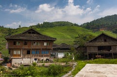 View of the village of Dazhai, with wood houses and rice fields along the slopes of the surrounding mountains in China stock image View of the village of Dazhai, with wood houses and rice fields along the slopes of the surrounding mountains in China stock image