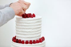 De banketbakker verfraait witte huwelijkscake stock afbeeldingen De banketbakker verfraait witte huwelijkscake stock afbeeldingen