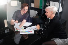 De bedrijfsvrouwen bespreken diagrammen bij Bureau in bureau stock foto's De bedrijfsvrouwen bespreken diagrammen bij Bureau in bureau stock foto's