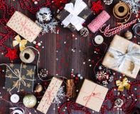 De giftvakje van de Kerstmisvakantie op verfraaide feestelijke lijst met de bal van de het rietkaars van het denneappelssuikergoe Stock Foto De giftvakje van de Kerstmisvakantie op verfraaide feestelijke lijst met de bal van de het rietkaars van het denneappelssuikergoe Stock Foto
