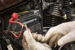De handen van de werktuigkundige die zekering in motorfiets vervangen en sele stock fotografie De handen van de werktuigkundige die zekering in motorfiets vervangen en sele stock fotografie