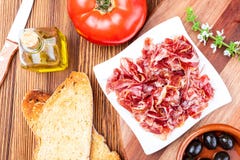 De heerlijke broodtoost met natuurlijke tomaat, extra eerste persing, Iberische ham, zwart olijven en basilicum gaat weg royalty-vrije stock afbeeldingen De heerlijke broodtoost met natuurlijke tomaat, extra eerste persing, Iberische ham, zwart olijven en basilicum gaat weg royalty-vrije stock afbeeldingen