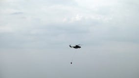 De helikopter van de ladingsbrand met opgeschorte afvoerkanaalgietlepel vliegt van reservoir stock videobeelden De helikopter van de ladingsbrand met opgeschorte afvoerkanaalgietlepel vliegt van reservoir stock videobeelden