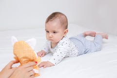 De jonge moeder speelt met haar gelukkige baby royalty-vrije stock afbeelding De jonge moeder speelt met haar gelukkige baby royalty-vrije stock afbeelding