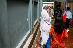 De katholieke Zuster spreekt met kinderen voor Huis van Moeder Teresa in Kolkata, India stock foto De katholieke Zuster spreekt met kinderen voor Huis van Moeder Teresa in Kolkata, India stock foto
