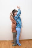 De kinderen vergelijken lichaamshoogte royalty-vrije stock afbeelding De kinderen vergelijken lichaamshoogte royalty-vrije stock afbeelding