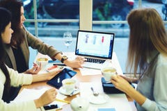 De kleren die van meisjesontwerpers samen het winkelen in sociale netwerken werken die producten van bedrijf via laptop en wifi t stock fotografie De kleren die van meisjesontwerpers samen het winkelen in sociale netwerken werken die producten van bedrijf via laptop en wifi t stock fotografie
