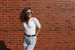 De manierportret van de de zomer zonnig levensstijl van jonge modieuze hipstervrouw met donkerbruin krullend meisje stock foto De manierportret van de de zomer zonnig levensstijl van jonge modieuze hipstervrouw met donkerbruin krullend meisje stock foto