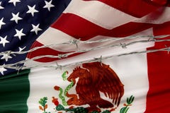 De Mexicaanse vlaggen van de V.S. en die door prikkeldraad worden gescheiden royalty-vrije stock foto De Mexicaanse vlaggen van de V.S. en die door prikkeldraad worden gescheiden royalty-vrije stock foto